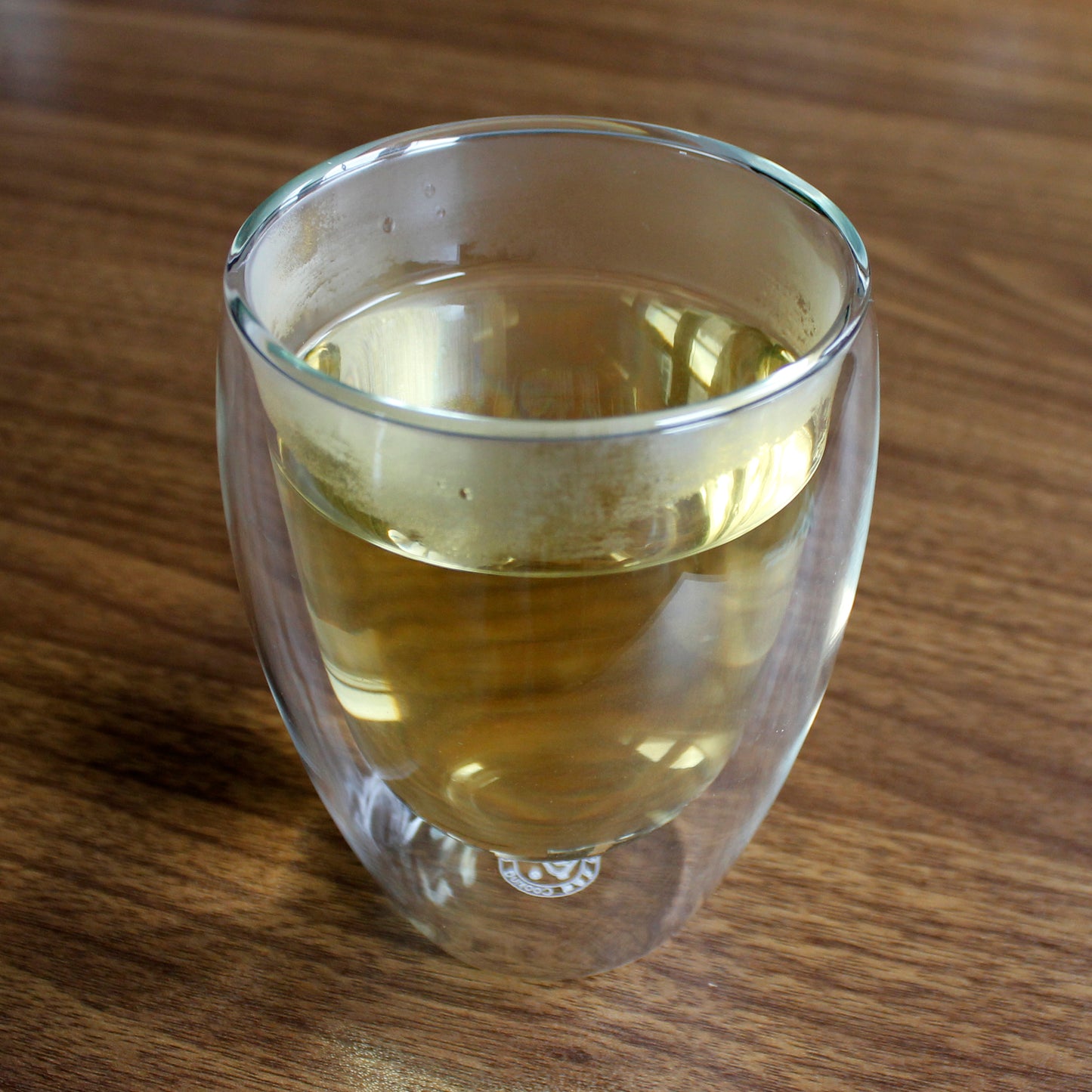 Glass double walled cup with tea.
