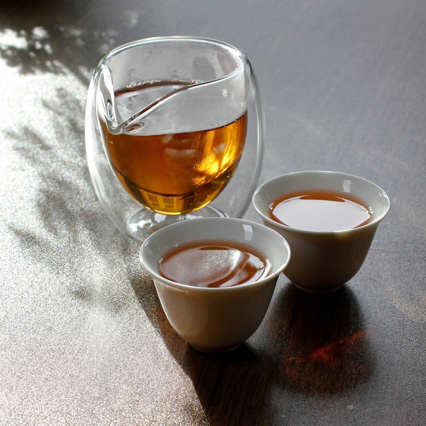 Bubble Sharing Pitcher - 8 oz - in use, two small white tea cups in front filled with tea.