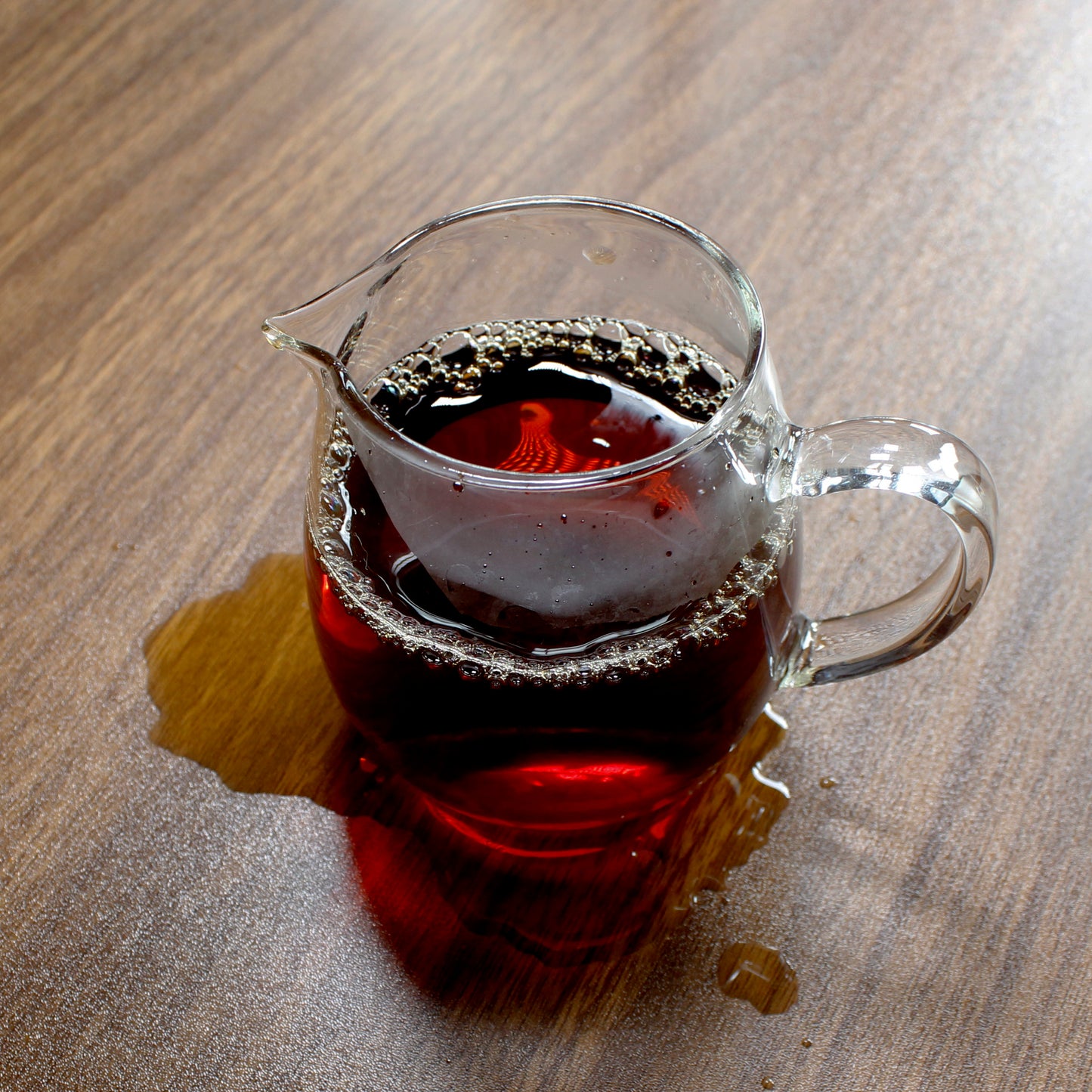 Tea in a glass pitcher on a wood table. Tasting Notes:
bran • walnut • black currant
