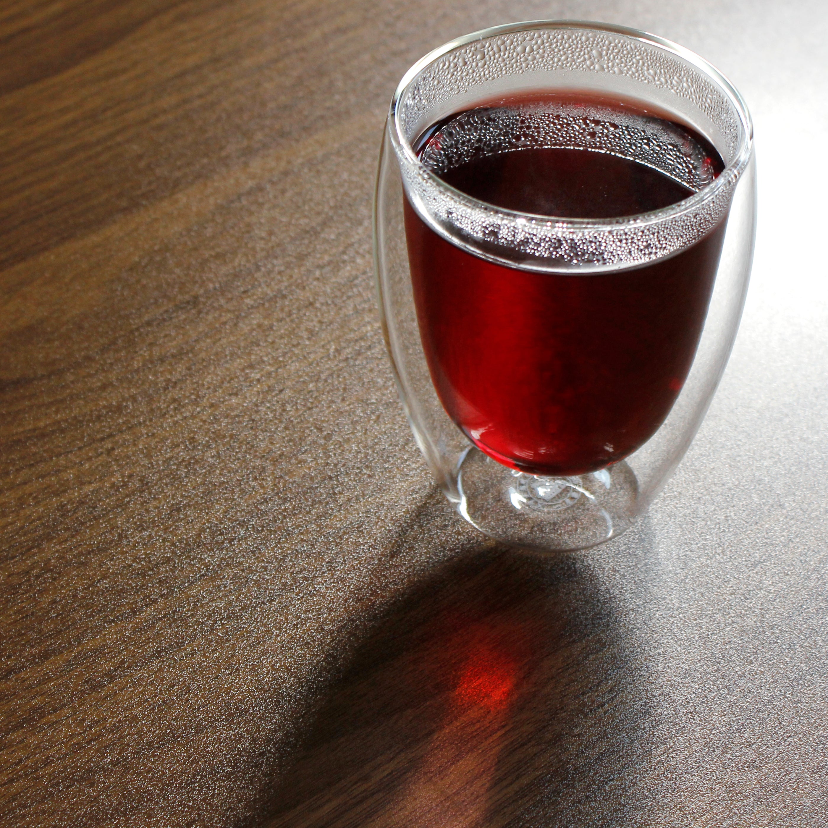 Deep red tea in the flared tasting cup.