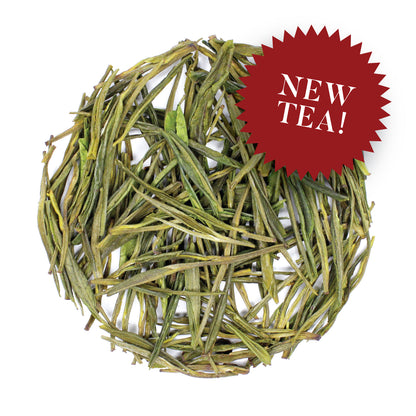 Loose pile of Anji Bai Cha on a white background. Ingredients: Camellia sinensis leaves.