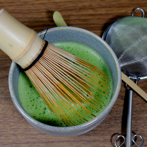 Whisked matcha, a beautiful frothy green, in a matcha bowl.