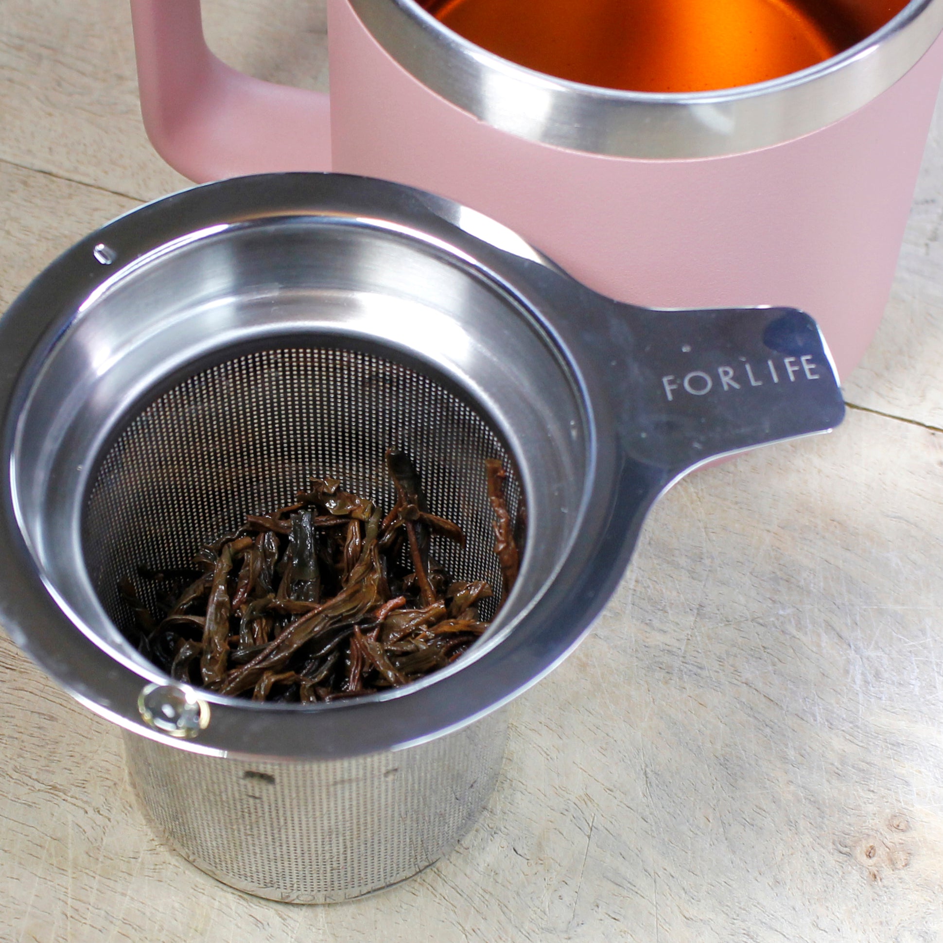 Tea infuser with wet tea leaves. 