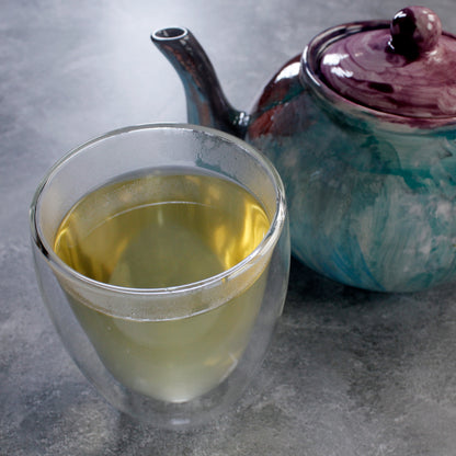 Ginger Lemon - infusion in a glass bubble cup with a blue purple teapot. Tasting Notes:
honey • citron • ginger