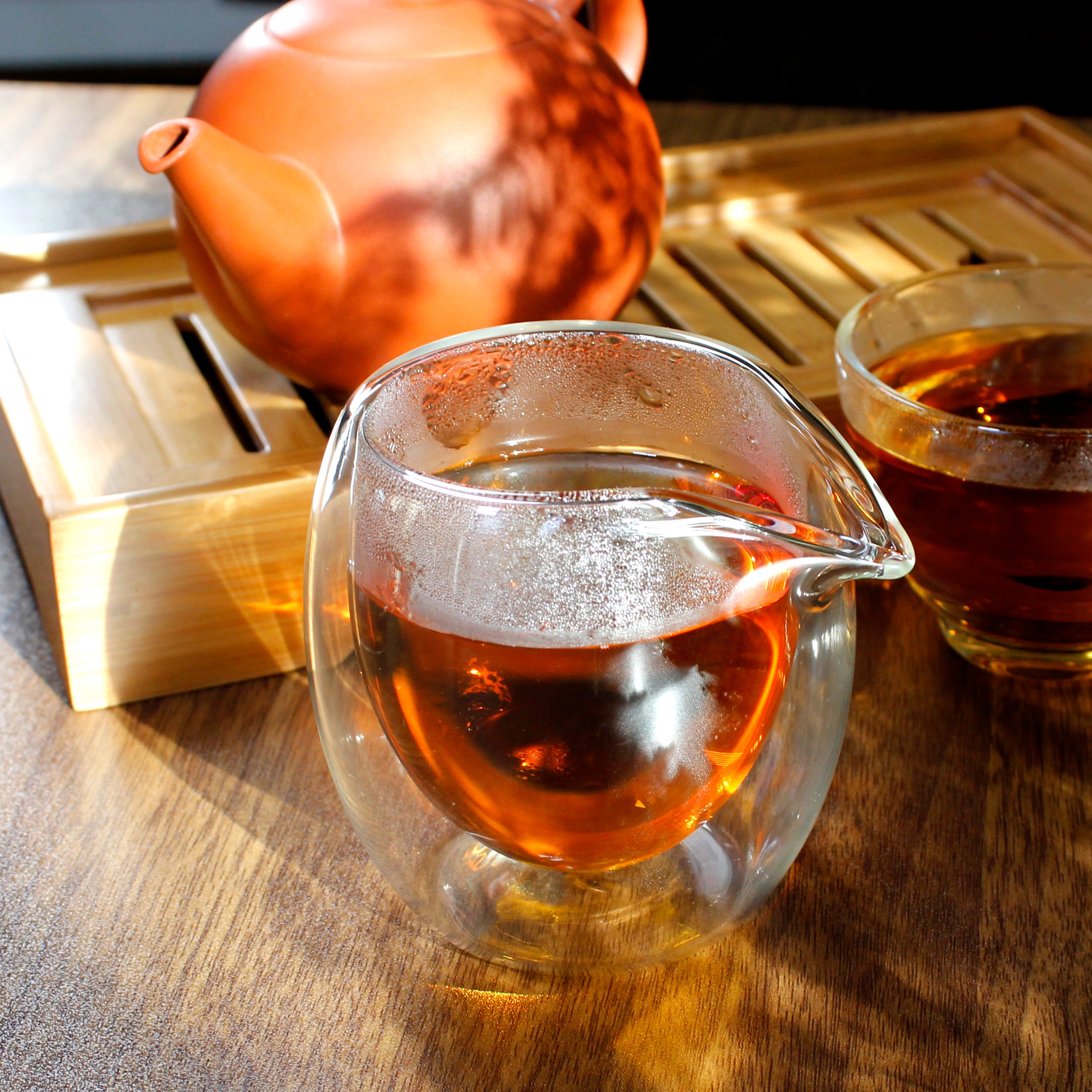 Bubble Sharing Pitcher - 8 oz - in use, small clay teapot is on a tea tray.
