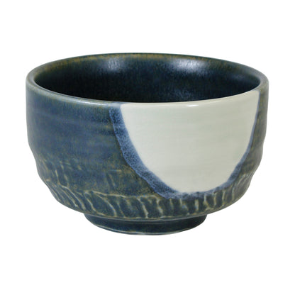 Green Chawan matcha bowl with white blue spot in the side with texture on a white background. 