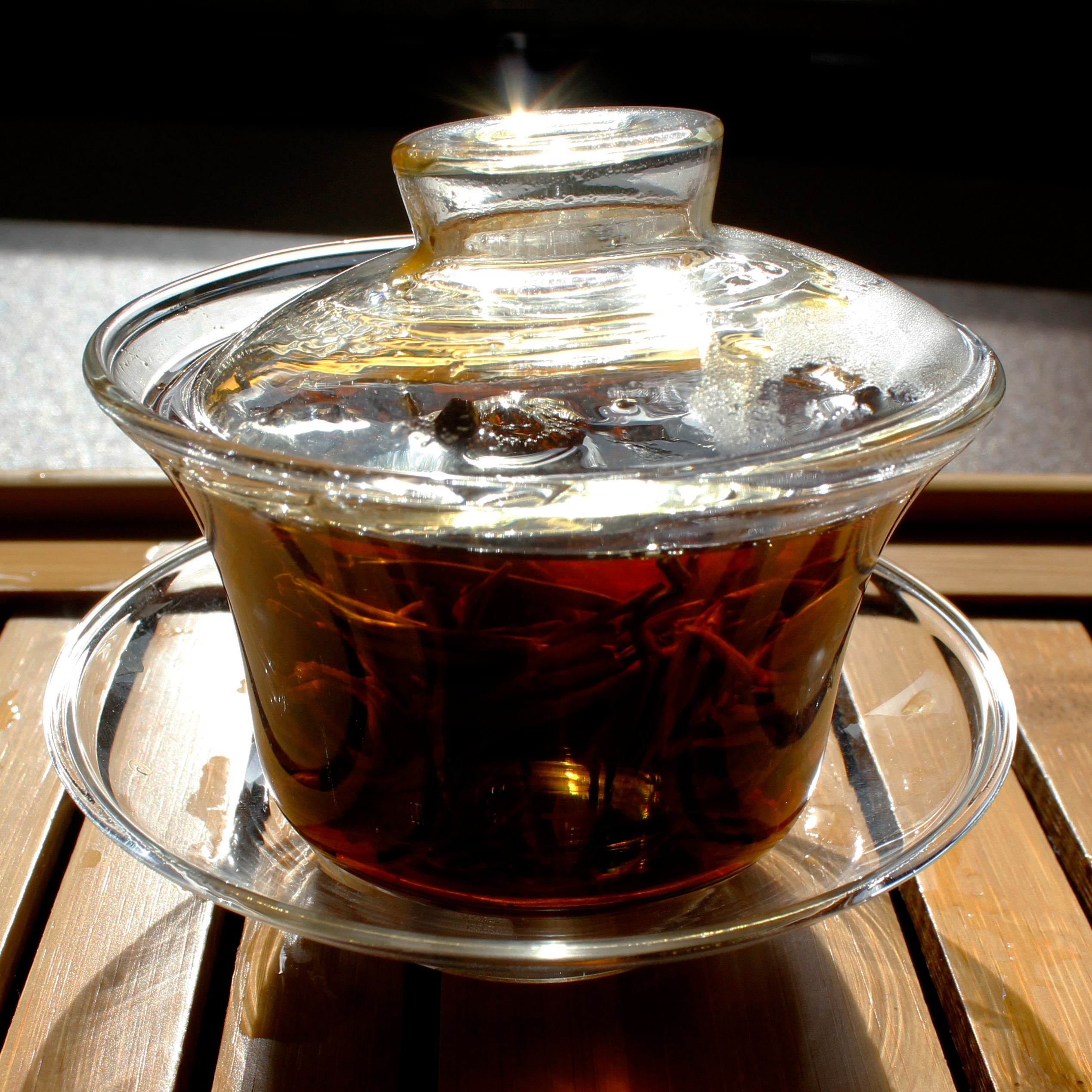 Gaiwan with brewed tea and leaves.