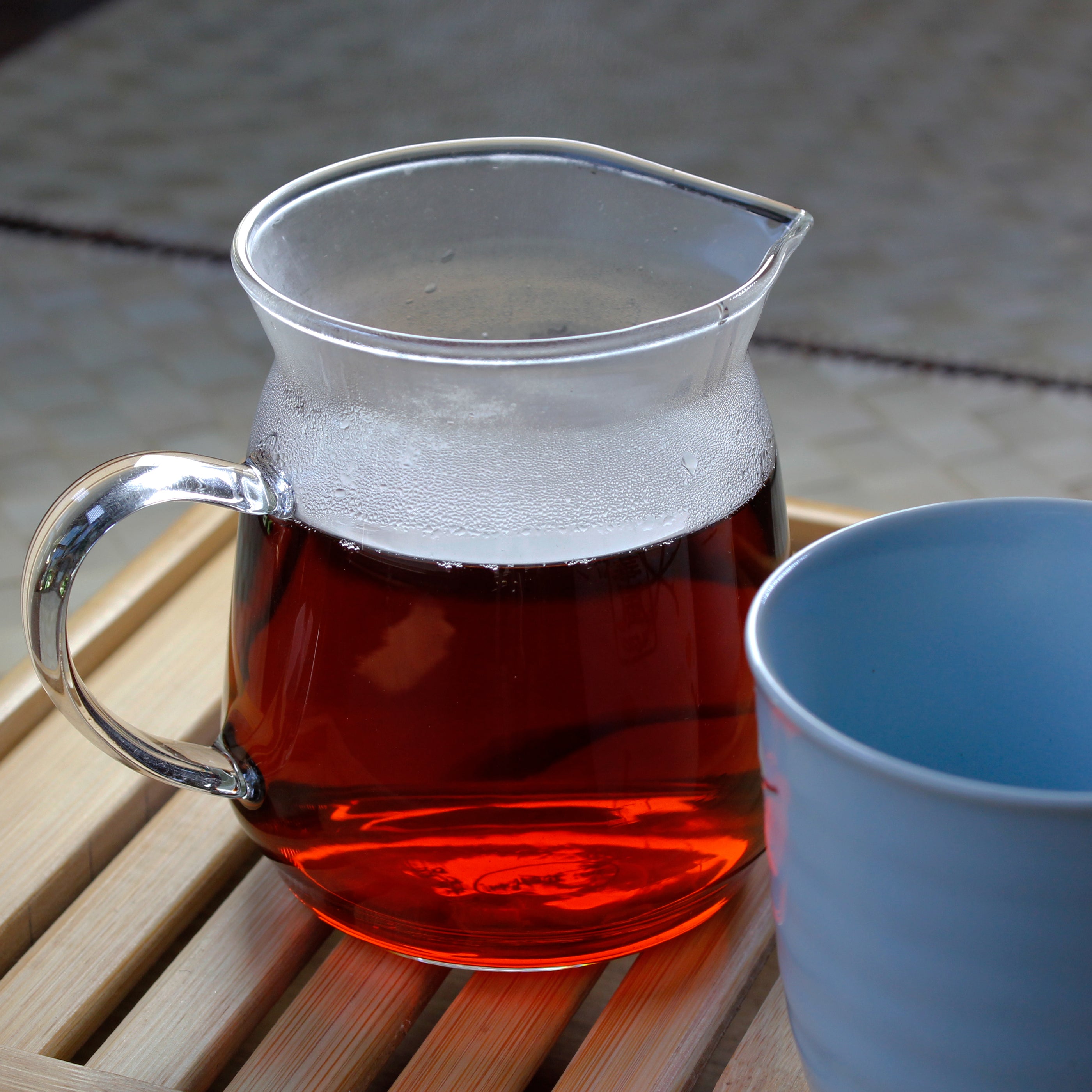 Tiger's Paw: Shu Pu-erh Bingcha - infusion in a glass pitcher on a bamboo tea tray. Tasting Notes:
burnt caramel • pine • sundried forest floor